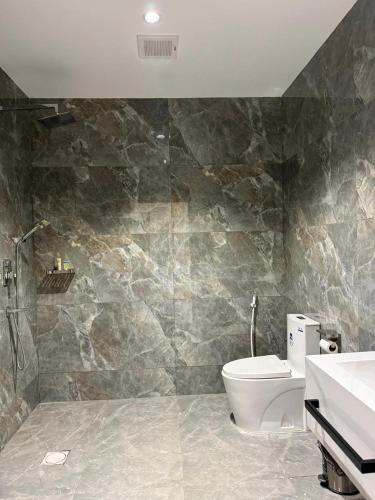 a bathroom with a toilet and a sink at Al Reef Garden in Sohar
