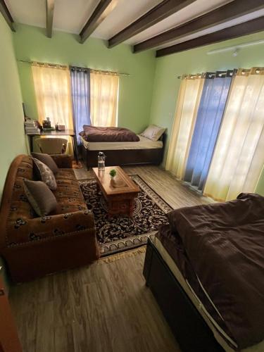 a living room with a couch and a table at The Norbu Retreat Hull in Kaza