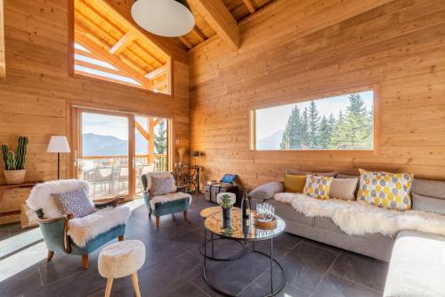 a living room with a couch and chairs at Chalet "Lucyvon" exceptional view in Manigod