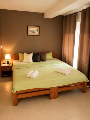a bedroom with a bed with two towels on it at Villa Stefan Ohrid in Ohrid