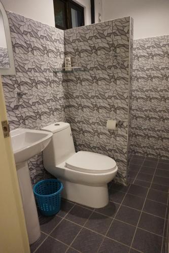 a bathroom with a toilet and a sink at Wellbeach Dive Resort in Zamboanguita