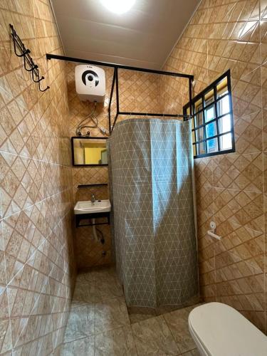 a bathroom with a shower and a sink at Archelux Developments in Bawalishi