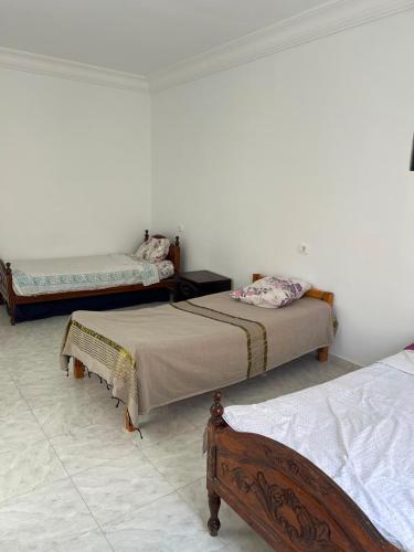 a bedroom with two beds in a room at Dar El corniche in Mahdia