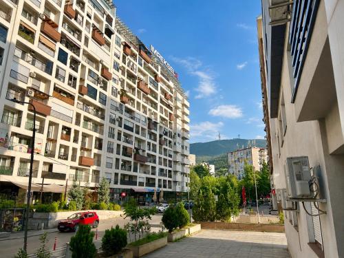 a large apartment building on a city street at Urban Taft Stay Skopje-Modern Vodno View Suite with Private Parking in Taftalidze in Skopje
