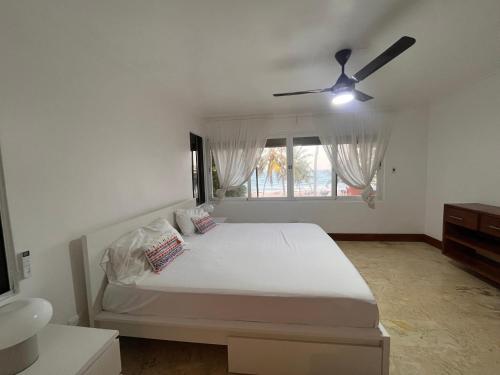 a bedroom with a bed and a ceiling fan at Villa Arena Blanca in Punta Cana