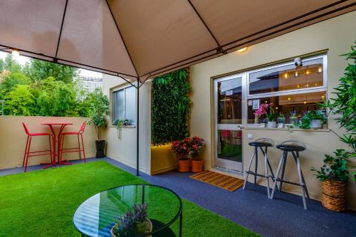 an outdoor patio with a table and stools at Avenue View Rooms in Porto