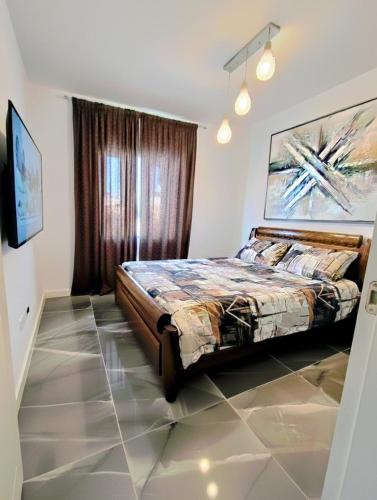 a bedroom with a bed and a painting on the wall at Tiberias 521 in Tiberias