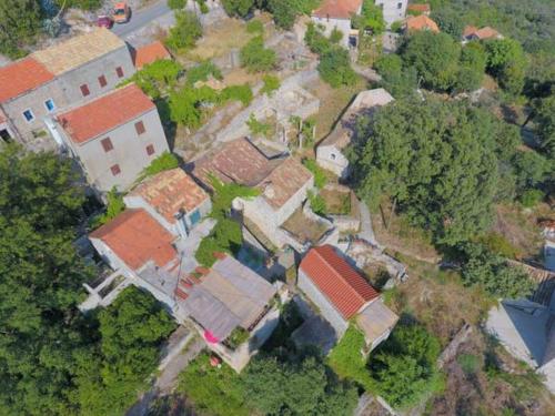 an overhead view of a group of houses with trees at Calypso's Cave the Apartment for Animal Lovers in Babino Polje