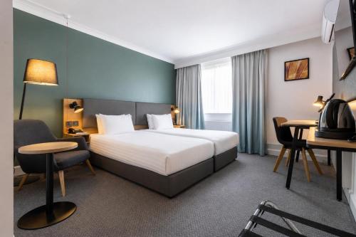 a hotel room with a bed and a desk at Holiday Inn Newport by IHG in Newport