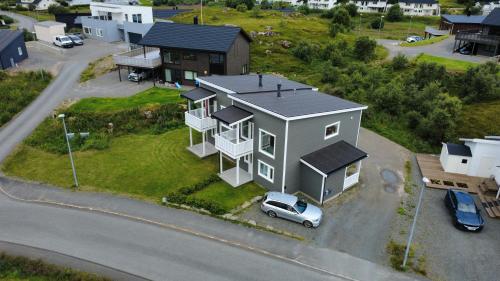 a small house with a car parked in front of it at Cozy Lofoten Hideaway in Leknes