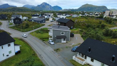 an aerial view of a village with houses and a road at Cozy Lofoten Hideaway in Leknes