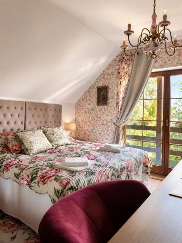 a bedroom with a bed with a floral bedspread at Apartamenty Kapitańskie in Oława