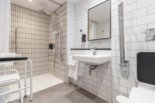 a white bathroom with a sink and a mirror at Holiday Inn Newport by IHG in Newport