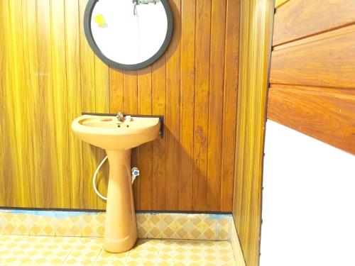 a bathroom with a sink and a mirror at saha surf camp in Arugam Bay