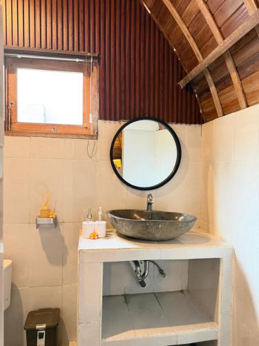 a bathroom with a sink and a mirror at Jordan Guest House in Uluwatu