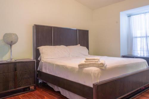 a bedroom with a large bed with a wooden headboard at Port St Lucie Poolside Oasis in Port Saint Lucie