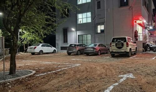a group of cars parked in a parking lot at Hotel Pooja Inn Pandharpur in Pandharpur