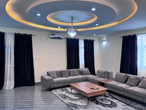 a living room with a couch and a coffee table at Tatkaba résidence in Conakry