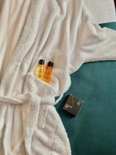 a white blanket with two bottles on top of it at Hotel Solun in Trieste