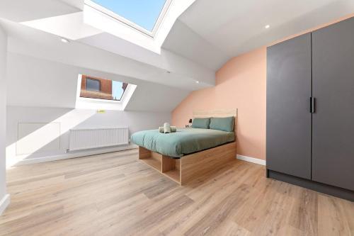 a bedroom with a bed and a skylight at Modern Studio in Central Leeds in Leeds