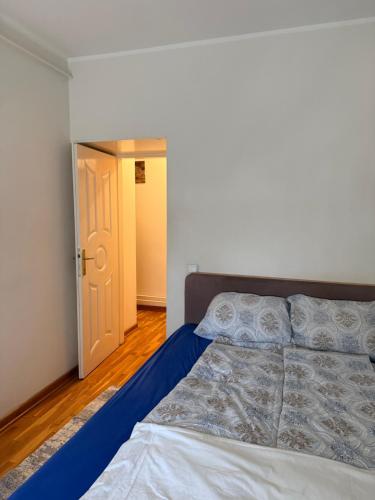 a bedroom with a bed and a door to a hallway at Dunav View Residence - River View Free Parking in Belgrade