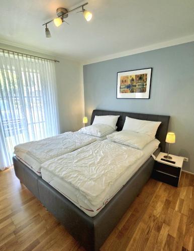 a bedroom with a large bed with white sheets at Köhler-Glowienka, Ute App Nr 3 in Schönberger Strand