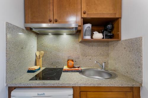 a kitchen with a sink and a counter top at Casa do Monte - Monção in Poças do Monte