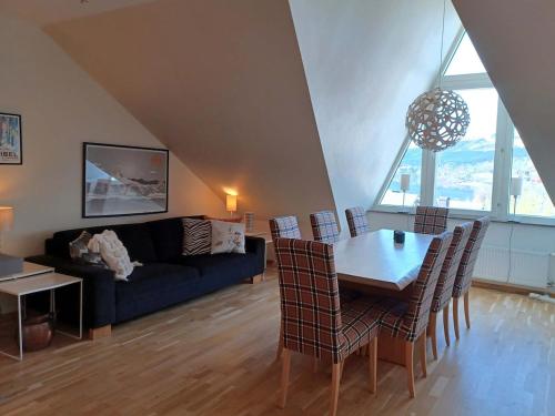 a living room with a couch and a table and chairs at Dählie Åre Torg Apartments in Åre
