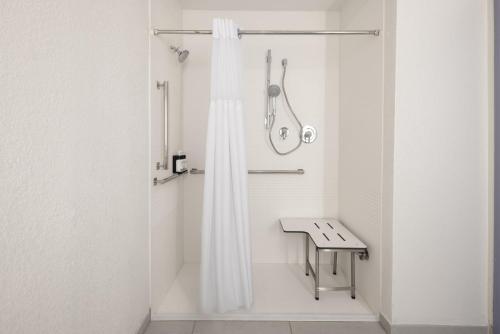 a bathroom with a shower with a shower curtain at Garner Hotel Sumter Northwest in Sumter