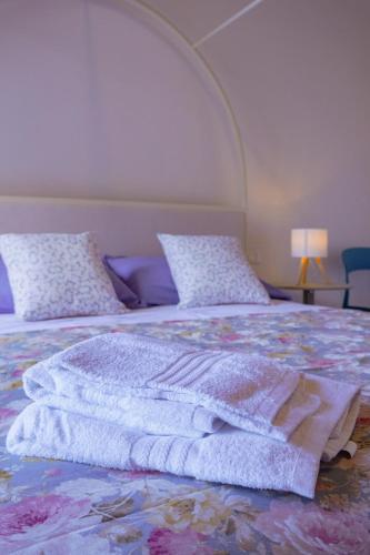a bed with a blanket and pillows on it at Oliveta del Tabernacolo in Malmantile