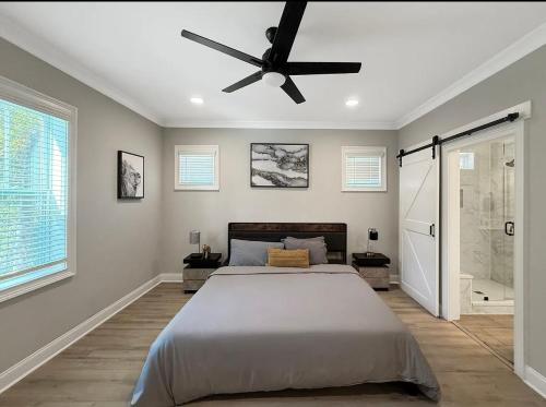 a bedroom with a bed and a ceiling fan at Charlotte NC in Charlotte