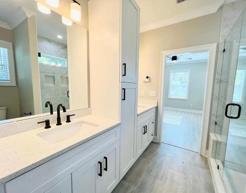 a white bathroom with a sink and a shower at Charlotte NC in Charlotte