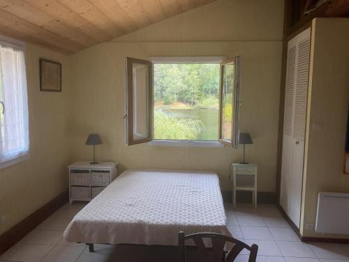 a bedroom with a bed and a window at Clairbois in Gérardmer