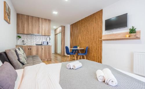 a room with a bed with two towels on it at Loft New Gudauri LT in Gudauri