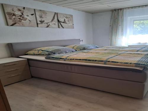 a bedroom with a bed and a window at Ferienwohnung Waldoase 