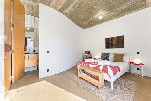 a bedroom with a bed with a red and white blanket at GuestReady - Freixo Apartments in Porto