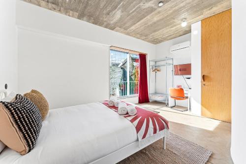 a bedroom with a white bed and a window at GuestReady - Freixo Apartments in Porto