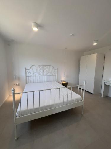 a bedroom with a white bed in a room at Ferienwohnung Casa Panorama in Beuren