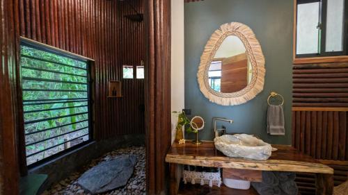 a bathroom with a large mirror and a tub at Beyond Alma Del Rio in Cristo Rey