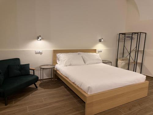 a bedroom with a bed and a black chair at Majella vista Mare in Guardiagrele