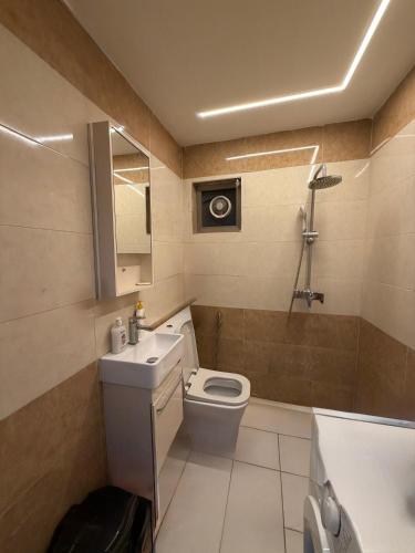 a bathroom with a toilet and a sink at شركة دار المعرفة للعقار in Baghdād