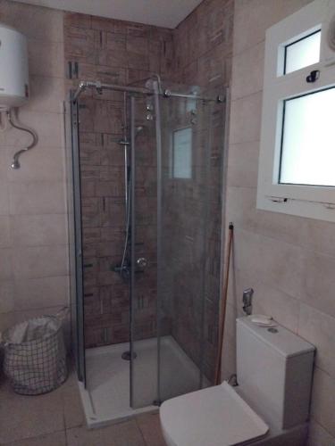 a shower stall in a bathroom with a toilet at Cozy studio in sahel in El Alamein