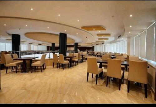 a dining room with tables and chairs in a building at Nozha Beach للعائلات in Ras Sedr