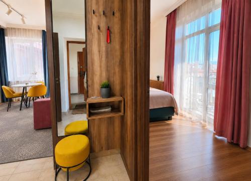 a hotel room with a bed and a yellow chair at Mountain View "Green Apartment" in Mukacheve