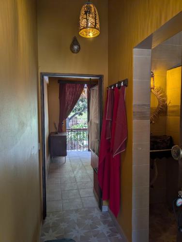 a bathroom with a walk in shower and red towels at ZenGardenCV in Lazareto