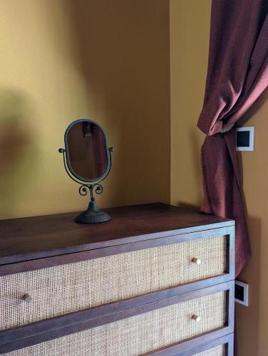 a dresser with a mirror on top of it at ZenGardenCV in Lazareto