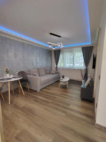 a living room with a couch and tables at David Apartament in Hunedoara
