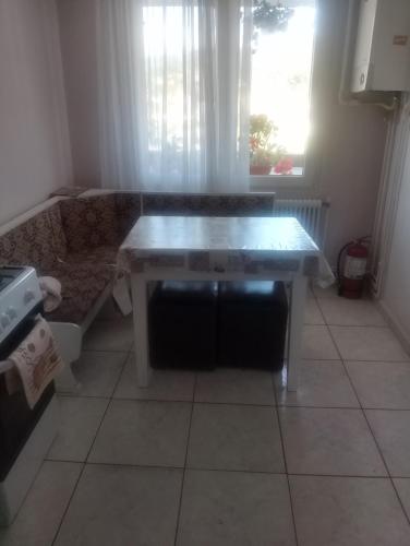 a kitchen with a table in a room with a window at Apartament Relax in Sovata