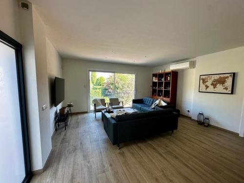 a living room with a couch and a table at Villa Las Dos Rocas in Calonge