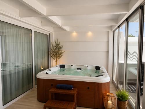 a jacuzzi tub in a room with a balcony at Villa Dru in Roquetas de Mar